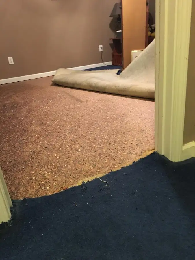 Carpet pad removal revealing water damage during Water Mitigation Services in Los Banos